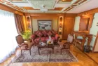 A panoramic view of Sonesta St. George Nile Cruise – sparkling hull and decks cruising Egypt’s historic Nile